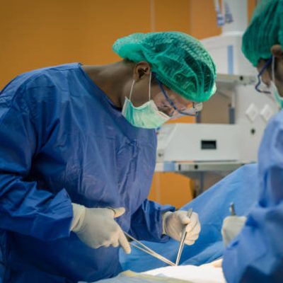 Doctor And Nurse Suture Patient In Emergency Room Doctor And Nurse Suture Patient In Emergency Room